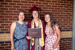 Elbit America employee Melissa Kidwell poses with her daughters. Mackenzie, in the center, recently graduated from high school and earned an Elbit Systems of America Dependent Scholarship in 2022.